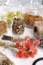 Bunches of dry flowers, different medicinal herbs and spool on white wooden table Royalty Free Stock Photo