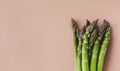 Bunches of fresh green asparagus on beige table top view Royalty Free Stock Photo