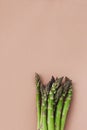 Bunches of fresh green asparagus on beige table top view Royalty Free Stock Photo