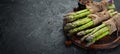 bunches of fresh green asparagus on a black background. Healthy food. Top view. Royalty Free Stock Photo