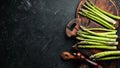 bunches of fresh green asparagus on a black background. Healthy food. Top view. Royalty Free Stock Photo