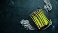 bunches of fresh green asparagus on a black background. Healthy food. Top view. Royalty Free Stock Photo