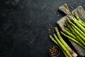 bunches of fresh green asparagus on a black background. Healthy food. Top view. Royalty Free Stock Photo