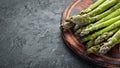 bunches of fresh green asparagus on a black background. Healthy food. Top view. Royalty Free Stock Photo