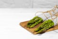 Bunches of Fresh Green asparagus in wooden desk on white background. Healthy vegetable diet. Vegetarianism. Vegetable