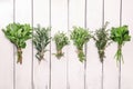 Bunches of fresh green herbs on white wooden table Royalty Free Stock Photo