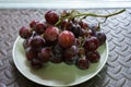 Bunches of fresh ripe red grapes on the dish. Ancient style, a b Royalty Free Stock Photo