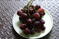 Bunches of fresh ripe red grapes on the dish. Ancient style, a b Royalty Free Stock Photo