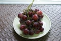 Bunches of fresh ripe red grapes on the dish. Ancient style, a b Royalty Free Stock Photo