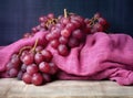 Bunches of fresh ripe red grapes on a wooden textural surface. Ancient style, a beautiful background with a branch of