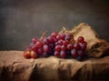 Bunches of fresh ripe red grapes on a wooden textural surface. Ancient style, a beautiful background with a branch of