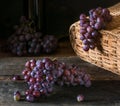 Bunches of fresh ripe red grapes on a wooden textural surface. Branch of pink grapes. Red wine grapes. dark grapes. Still life of Royalty Free Stock Photo