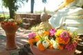 Bunches of Lotus and Marigold Flowers for the Offering with Blurry Buddha Images in Background, Thailand Royalty Free Stock Photo