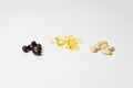 Bunches of multivitamins, fish oil and astaxanthin. Polyunsaturated fatty acids in the middle. White background. Close-up