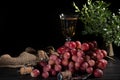 Bunches of pink grapes and green apples on a dark background. A glass of champagne is in the background. Still life. Vitamin Royalty Free Stock Photo