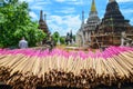 Bunches of pink incense sticks are being dried by the sun