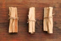 Bunches of tied Palo Santo sticks on wooden table, flat lay