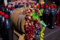 Bunches of white, pink and dark grapes on an old wooden wine barrel.