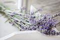 Bundeled bunch of lavender stems on a white tray on wooden table Royalty Free Stock Photo