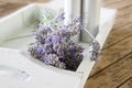 Bundeled bunch of lavender stems on a white tray on wooden table. Royalty Free Stock Photo