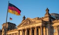 The Bundestag building, Parliament of the Federal Republic of Germany, with German flag flying outside. Royalty Free Stock Photo