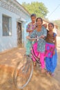 Portrait of three teenage girls posing in front of a traditional house in a village close to Bundi