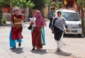 Three Indian women with colorful veil and, sari