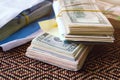 Bundle of american dollar banknotes in white envelope on wooden table. Secondary black economy concept. Envelope wages. Bribery