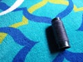 Bundle of Black Threads on Colorful Carpet, Suitable for Sewing or Weaving Use