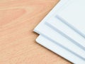 A bundle of blank white paper on wooden table. Royalty Free Stock Photo