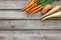 Bundle of carrots, parsnip and sweet potato on a rustic table Royalty Free Stock Photo