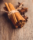 Bundle of cinnamon and anise stars on the rustic wooden background Royalty Free Stock Photo