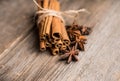 Bundle of cinnamon and anise stars on the rustic wooden background Royalty Free Stock Photo