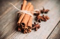 Bundle of cinnamon and anise stars on the rustic wooden background Royalty Free Stock Photo