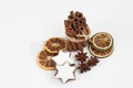 Bundle of cinnamon sticks staranises dried orange slices christmas pastries on white background Royalty Free Stock Photo