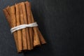 Bundle of Cinnamon Sticks Tied Together on Black Background with Royalty Free Stock Photo