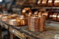 A bundle of coiled copper wires neatly arranged on a workbench, highlighting the organized chaos and metallic texture Royalty Free Stock Photo