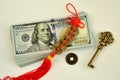 A bundle of 100 dollar bills a key and chinese coins talismans to attract wealth and success