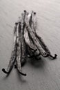 Bundle of dried bourbon vanilla beans or pods on black stone board