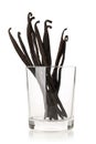 Bundle of dried bourbon vanilla beans or pods in glass over white Royalty Free Stock Photo