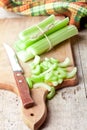Bundle of fresh green celery stems and knife Royalty Free Stock Photo