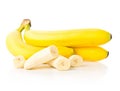 Bundle of fresh, ripe, yellow bananas with sliced banana pieces