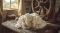 bundle of freshly sheared wool, soft and fluffy, resting on a rustic wooden table Royalty Free Stock Photo