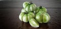 A bundle Green Fresh Tomatoes and a piece of Tomato