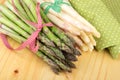 Bundle of green and white asparagus on bright wood. Royalty Free Stock Photo