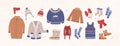 Bundle of knitted winter clothes and outerwear isolated on light background - woolen sweater, cardigan, waistcoat, snow