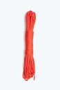 Bundle of neatly twisted red nylon rope on a white vertical background Royalty Free Stock Photo