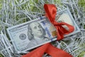 A bundle of one hundred dollar bills tied up with a red ribbon Royalty Free Stock Photo