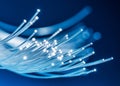 Bundle of optical fibers with lights in the ends. Blue background Royalty Free Stock Photo
