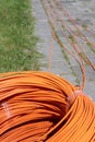 Bundle of orange fiber optic cables lie on a street